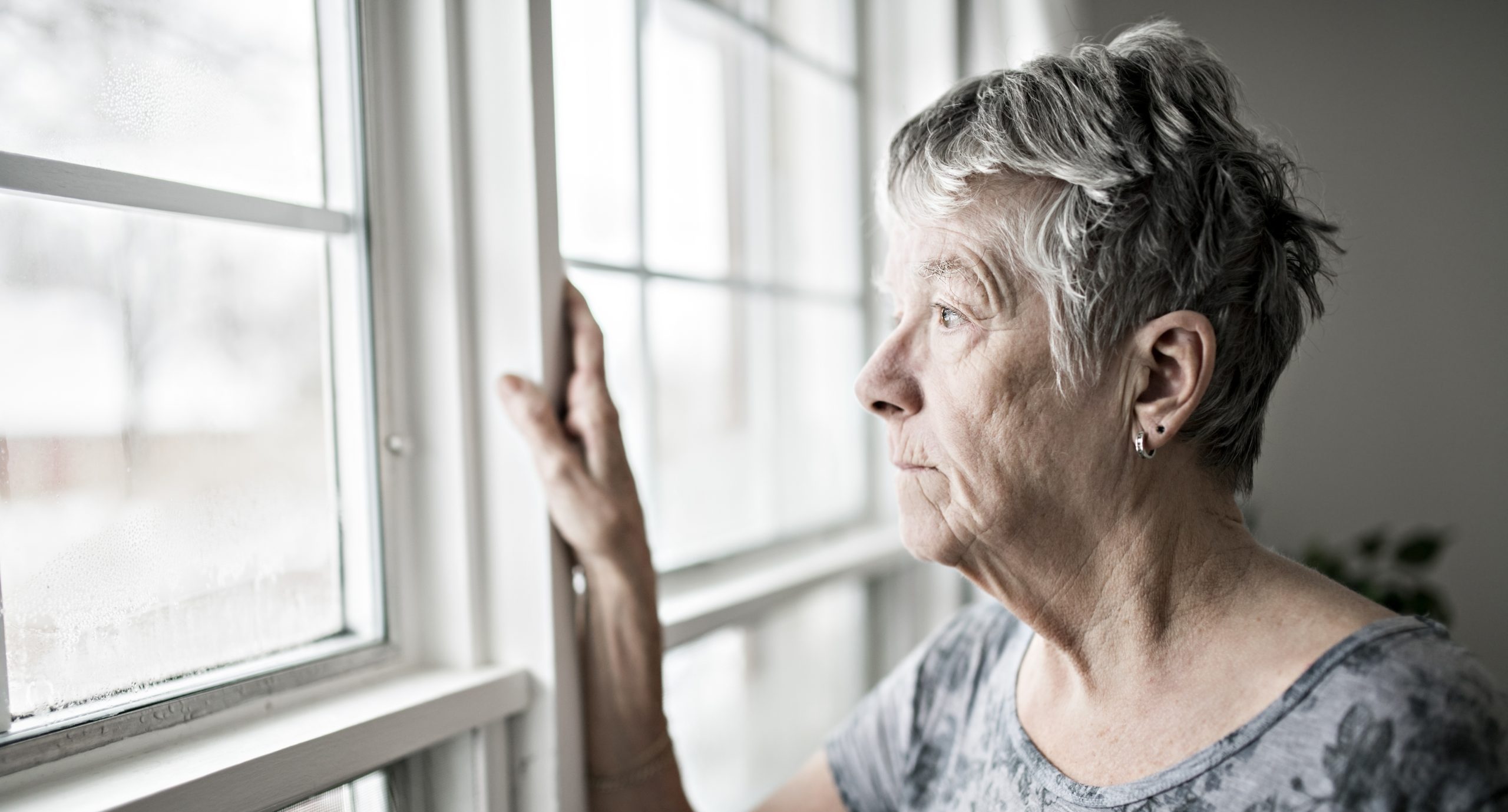 a sad lonely 70 years old senior in is apartment