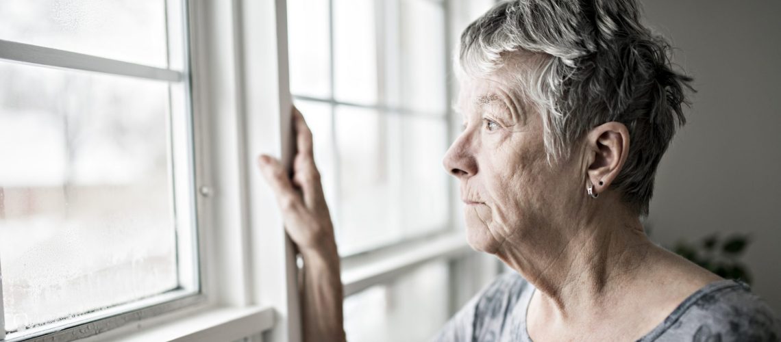 a sad lonely 70 years old senior in is apartment